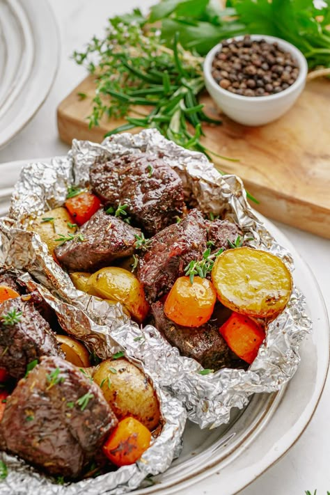 Foil packs of steak, potatoes, and carrots. Foil Steak And Potatoes Oven, Chicken And Potato Foil Packets Ovens, Steak Potatoes And Carrots, Hobo Foil Packs, Foil Food Packaging, Aluminum Foil Meals, Tray Meals, Foil Chicken, Ancestral Eating