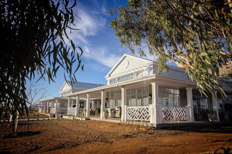 Australian Hamptons Look. The Queenslander style with wrap around verandah meets the luxe detail of the Hamptons style with gables detailed with vents, arbors and tansom windows. Linea weatherboard 180mm in Dulux Milton Moon paint contrasting trims and balustrades in Dulux Lexicon Quarter paint. Dulux Lexicon, Australian Hamptons Style, Hampton Mansion, Hamptons Homes, Hampton Estates, Hamptons Style Homes, Barn Style Sliding Doors, James Hardie, Farm Projects