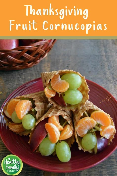 Thanksgiving Fruit Cornucopias | Create a fun display for your Thanksgiving table with these Fruit Cornucopias. A great activity to keep the kids busy, set them up with cones and fruit and let them create their own! | Healthy Family Project #fruitcornucopias #thanksgivingrecipe #thanksgivingtablescapes #fruit #healthy #treats Thanksgiving Food Fun Kids, Cornucopia Fruit Cone, Cornucopia Snack For Kids, Fruit Cornucopia For Kids, Thanksgiving Fruit Ideas For Kids, Fruit Platter For Thanksgiving, Thanksgiving Party Snacks For Kids, Thanksgiving Appetizers Kids, Thanksgiving Kid Desserts