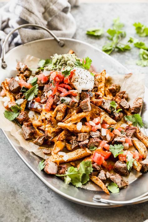 Carne asada fries are the best game day appetizer, but they also make a fun dinner. Crispy seasoned fries, juicy steak, and ALL the toppings! Carne Asada Fries Recipe, Carne Asada Steak, Carne Asada Fries, Parsnip Fries, Well Plated, Holiday Meal Planning, Easy Taco Recipes, Seasoned Fries, Smoked Chicken Wings