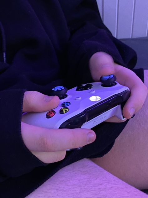 a boy holds a gaming controller in his hands Gamer Purple Aesthetic, Video Games With Friends Aesthetic, Gaming Hobby Aesthetic, Gamer Core Aesthetic, Gamer Vibes Aesthetic, Purple Gaming Aesthetic, Purple Gamer Aesthetic, Gaming Girl Aesthetic, Teenage Novel