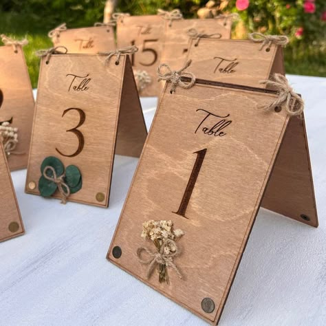 Double-side engraved, these wooden table numbers will add a rustic bohemian flair to your table decor. Each sign is accentuated with brass eyelets and your choice of eucalyptus or Gypsophila flower on both sides. Wood Wedding Table Numbers, Wood Frame Ideas, Table Numbers Wood, Wood Wedding Table, Wood Box Ideas, Wood Laser Cut Ideas, Wood Wedding Decorations, Wood Table Numbers Wedding, Laser Wedding