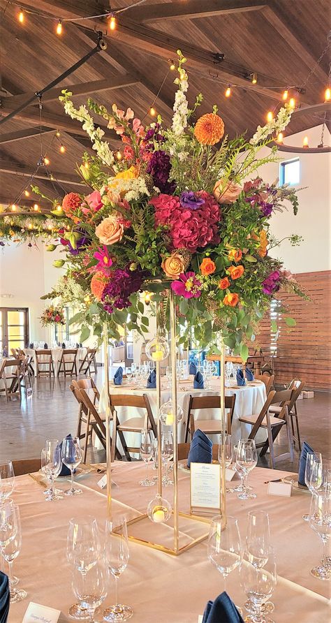 Tall Centerpieces Diy, Simple Colorful Floral Centerpieces, Tall Table Centerpieces, Colorful Centerpieces Wedding, Tall Flower Centerpieces With Candles, Colorful Tall Centerpieces Wedding, Vibrant Floral Centerpieces, Bright Floral Wedding Centerpieces, Wedding Table Set Up