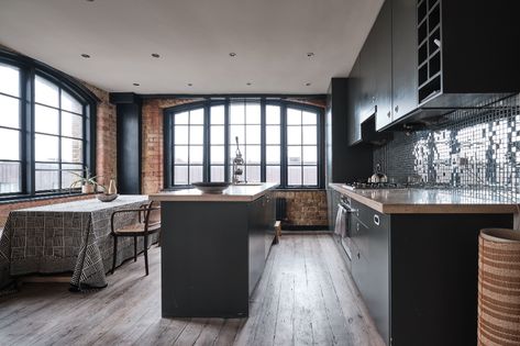 Lion Mills, London E2 - Aucoot Converted Warehouse Apartment, Warehouse Apartment, Converted Warehouse, Wrought Iron Staircase, Iron Staircase, Natural Stone Countertops, Industrial Style Kitchen, Long Dining Table, Built In Seating