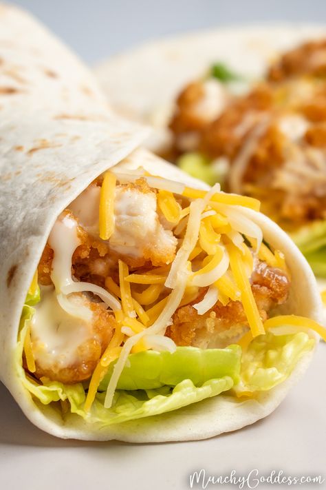 Air fryer snack wrap filled with breaded chicken, romaine lettuce, shredded Cheddar Jack cheese, and ranch dressing on a light gray plate. Crispy Chicken Snack Wraps, Crispy Chicken Lunch Ideas, Mcdonald’s Crispy Chicken Wrap, Mc Donalds Chicken Wrap, Popcorn Chicken Wrap, Snack Wraps Chicken, Mcdonalds Crispy Chicken Snack Wrap, Chicken Tender Tortilla Wrap, Crunchy Chicken Wraps