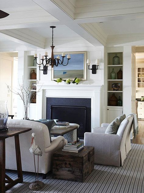 Two doorways flanking both sides of a large built-in storage unit and fireplace combo create an open passageway between the living room and kitchen. Including two doorways not only adds to the openness of the home, but it also lends a sense of balance that blends well with the traditional-style decor. Tammy Connor, Living Room Ideas With Fireplace, Living Room Furniture Layout, Fireplace Built Ins, Traditional Style Decor, Rooms Ideas, Trendy Living Rooms, Room Partition, Furniture Layout