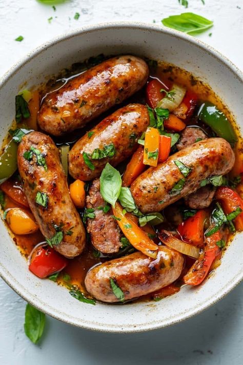 A hearty bowl of Crockpot Sausage and Peppers with Italian sausage links, colorful bell peppers, and fresh basil in a savory sauce. Healthy Ground Italian Sausage Recipes, Sausage Peppers And Onions Crockpot, Crockpot Sausage Recipes, Sausage Link Recipes, Braised Sausages, Crockpot Sausage And Peppers, Crockpot Fall Recipes, Slow Cooker Sausage And Peppers, Ground Italian Sausage Recipes