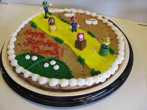 Add decorations like Super Mario Bros. to a cookie cake to match your party theme. Super Mario Cookie Cake, Mario Cookie Cake, Cookie Cake Designs, Mario Birthday, Birthday Cookies, Cookie Cake, 7th Birthday, Super Mario, Bday Party