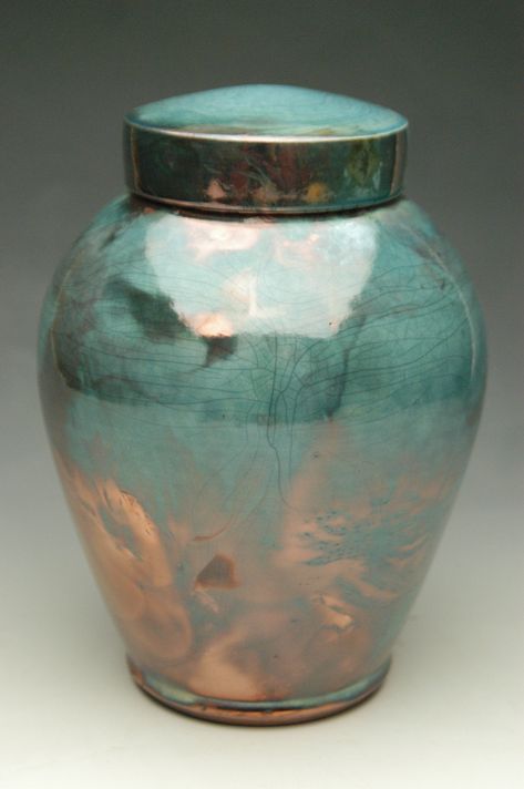 The Handmade Celestial Raku Ceramic Cremation Urn is hand-thrown in the traditional Japanese Raku-fired ceramic art process. A very popular style for ceramic urns, this handmade art piece is individually handcrafted in honor of your loved one by a ceramic artist in the U.S.A. With Raku ceramics, each piece of pottery is taken from the kiln red hot, the molten glaze silken and glowing. Then it is placed in a bed of straw or leaves in an air-tight container. The dry plant material immediately bursts into flame as the “reduction chamber” is sealed. The flame and the smoking oxygen-starved atmosphere transform the glaze surface, creating raku's unique, seemingly ancient colors and textures. Thus, each of our Raku-fired funeral urns are one of a kind and completely unique in the particulars of Wood Pet Urn, Companion Urns, Wood Urn, Ceramic Urn, Raku Ceramics, Keepsake Urns, Cultured Marble, Art Process, Memorial Urns