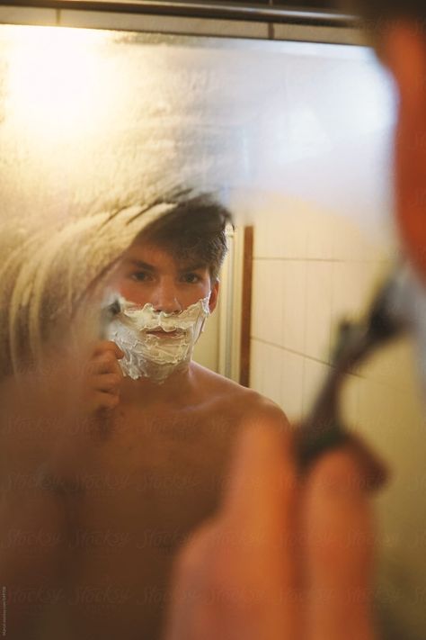 Young man shaving in front of the mirror, with soap and razor Male Shower Aesthetic, Shaving Aesthetic Men, Man In Mirror Photography, Man In Front Of Mirror, Bathtub Photoshoot Male, Man In Bathtub Photography, Shaving Photography, Man Shaving Aesthetic, Man Looking In Mirror