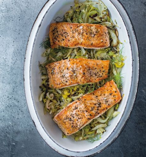 Salmon with Leeks, Fennel and Lemon | Baking salmon on top of leeks and fennel is an easy method for preparing the flavorful fish, and it takes less time than cooking all the components separately. Leek And Salmon Recipe, Salmon With Leeks, Fennel Salmon Recipes, Fish And Leeks Recipe, Salmon And Leeks, Salmon And Leek Recipes, Leek And Fennel Recipe, Salmon And Leeks Recipe, Salmon Fennel Recipe