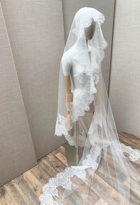 "This grand luxurious mantilla style veil features feminine vintage inspired Chantilly lace beautifully framing the face. This veil is made in the wider width insuring an elegant drape. The veil is secured in your hair with the comb on top of your head. The veil in the photos is a cathedral length and measures 110\" long from the hair comb to the bottom of the veil. Other lengths are available as well. The color of the veil is soft white and will compliment white, off white or light ivory dresses. * RETURN POLICY - We do not accept returns for a refund as all of out items are made to order. But please contact us if you are having an issue with your order. - We do accept exchanges. You can exchange your items for something else in our shop. The items you would like to exchange should be shi Long Veil Wedding Dress, Veil Over Face, Spanish Veil, Lace Trim Veil, Winter Gothic, Chantilly Lace Trim, Lace Trimmed Veil, Spanish Mantilla, Mexican Lace