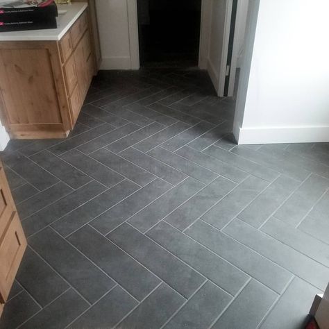 Herringbone bathroom tile Black Floor Tile Laundry Room, Slate Grey Bathroom Tile, Black Herringbone Tile Floor Entryway, Farmhouse Kitchen With Tile Floor, Slate Herringbone Tile Floor Bathroom, Kitchen Ideas With Tile Floors, Dark Bathroom Floor Tile Ideas, Herringbone Tile Floor Mudroom, Gray Slate Tile Bathroom