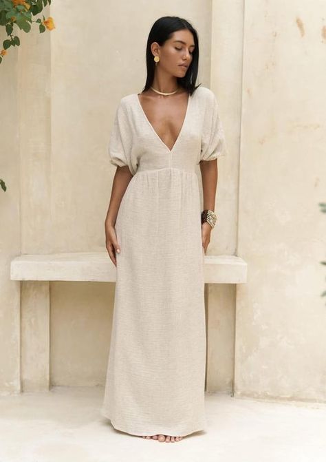 Hey sunshine! Embrace your inner goddess with our Minimal Hemp & Cotton Maxi Dress. This beach boho wrap dress is the epitome of effortless style, perfect for a beach wedding or a laid-back garden party. Crafted from breathable linen, this bohemian hemp dress boasts a backless design that adds a touch of allure. Whether you're a wedding guest or the bride-to-be opting for a simple wedding dress, this long hemp dress exudes charm and elegance. Embrace the cottagecore aesthetic with this modest yet stunning piece that will make you feel like a boho queen. Get ready to turn heads in this minimal linen dress that radiates understated beauty. Product Description: Backless dress made from a cotton blend. Off-the-shoulder design with ruched elastic sleeve details, straight-cut dress. Unlined. Pro Beige Linen Bridesmaid Dress, Linen Wedding, Beige Linen Relaxed Fit Beach Dress, Beach Linen Beige Maxi Dress, Dress Wedding Guest, Ivory Boho Dress, Cream Maxi Length Beach Cover-up Dress, Chic V-neck Linen Beach Dress, Off-white Linen Beach Dress