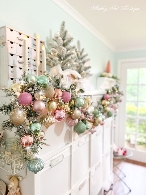 Pink Whimsical Christmas Tree, Extra Christmas Decor, Christmas Boutique Crafts, Craft Room Christmas Tree, Pastel Christmas Mantle, Christmas Decor Ideas For Boutique, Pink Christmas Display, Pink And Green Nutcracker, Pink Christmas Fireplace Decor