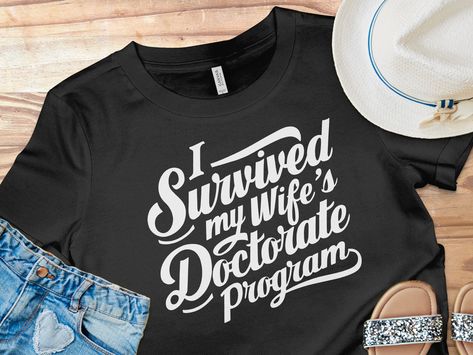 Celebrate the monumental achievement of your spouse completing her doctoral journey with this humorous and lighthearted T-shirt.

#graduation2024
#FinishEDD
#PhinisheD
#PHD
#EDD
#graduationcapdesigns
#graduationpartyideas
#graduationgiftideas
#graduationoutfitideas Social Work Graduation Party, Social Work Graduation, Doctorate Graduation, Phd Gifts, Graduation Cap Designs, Graduation Parties, Graduation Outfit, Art Idea, I Survived