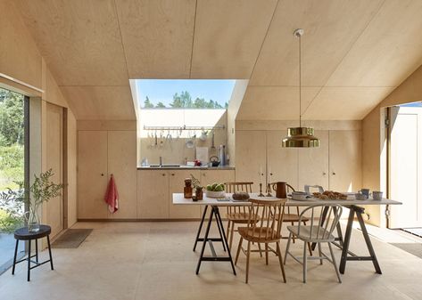 Windows filter the light through to the bright interior of this modern house that features birch plywood walls, ceiling, and floor. #PlywoodWalls #PlywoodInterior #Windows #Kitchen Swedish Cabin, Swedish Summer House, Workshop Architecture, Plywood Ceiling, Plywood House, Skylight Kitchen, Plywood Interior, Small Lounge, Plywood Walls