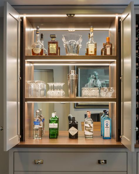 / Hidden features - a bar area with pocket doors that can be brilliantly concealed when open, revealing an elegant mirrored walnut interior. #homebar #bespokebar #barinteriors #bespokejoinery #cabinetry #pocketdoors #walnutinterior #langstaffellis #bespokeinteriors #luxuryinteriors #bespokefurniture #britishdesign Luxury Mini Bar At Home, Bar Area In Home, Home Wine Rack, Luxury Home Bar, Walnut Interior, Mini Bar At Home, Bespoke Home, Hidden Bar, Bar Designs