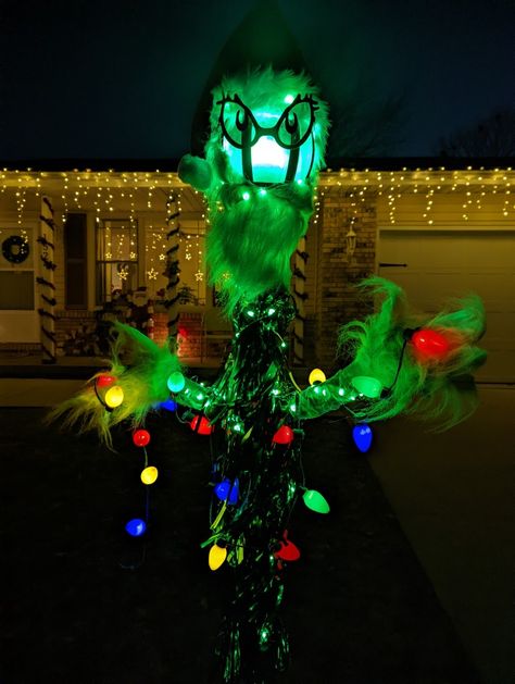 I added fairy lights and Christmas light necklaces to light him up at night! Grinch Lamp Post, Outdoor Christmas Lights Grinch, Grinch Taking Lights Off House, Outdoor Lights Grinch, Christmas Light Necklace, Grinch Christmas Sculptures & Statues, Fairy Lights, Grinch, Christmas Lights