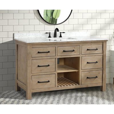 Welcome warm, rustic style into your main bathroom with this 55" wide single vanity. It's made from solid fir wood, and features natural wood knots and wood grain variation for a weathered, lived-in look. Matte black drawer pulls add just the right finishing touch. We love that this vanity's six drawers are soft-close to keep little fingers safe, and that there's two open cubbies that give you even more room for toiletries and towels. It comes with a white marble countertop, ceramic undermount s Farmhouse Style Bathroom Vanity, Engineered Stone Countertops, Carrara Marble Countertop, Wood Bathroom Vanity, Bathroom Farmhouse Style, White Marble Countertops, Marble Countertop, Single Sink Bathroom Vanity, Main Bathroom