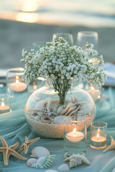 14 Enchanting Baby's Breath Centerpieces For Every Occasion • Confetti & Roses Sea Shell Flower Arrangements, Simple Beach Wedding Flowers, Ocean Baby Shower Centerpieces, Simple Beach Wedding Ideas Decor, Beach Flower Arrangements, Flowers For Beach Wedding, Elegant Beach Wedding Decorations, Beach Wedding Table Decorations, Decoration Theme Marin