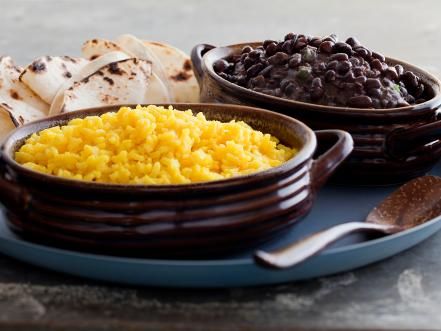 From tacos and nachos to margaritas, get the most-delicious recipes to cook up our favorite Mexican fiesta foods for your next dinner or party. Yellow Rice And Black Beans Recipe, Mexican Fiesta Food, Spicy Black Beans, Tyler Florence Recipes, Yellow Rice Recipe, Rice And Black Beans, Yellow Rice Recipes, Mexican Side Dishes, Black Beans And Rice