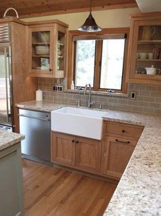 Ideas to update an oak kitchen by adding glass to the solid doors. Shown with granite top and apron front sink. Photo via Zillow, design by Robert Adam Dorn #KitchenCabinets Trendy Kitchen Tile, Trendy Kitchen Backsplash, Best Kitchen Cabinets, French Farmhouse Decor, Farmhouse Kitchen Cabinets, Kitchen Colour Schemes, New Kitchen Ideas, Honey Oak, New Kitchen Cabinets