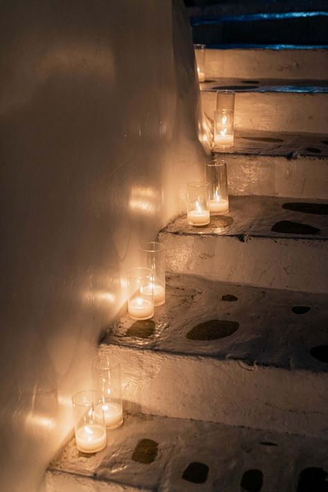 The traditional Cycladic whitewashed stairs of Remezzo Mykonos were decorated with glass cylinder candles | Mykonos Wedding Planner & Designer: @mitheoevents Photo: @sotiristsakanikas Venue: @remezzomykonos | #mitheoevents #weddingplannergreece #mykonosweddingplanner #mykonoseventplanner #mykonosevent #welcomedinner #nauticaldinner #seasidedinner #birthdayevent #remezzomykonos #greekisland #eventstyling #eventdecor #stairs #candles #candledecor Staircase With Candles, Candle Stairs, Seaside Dinner, Erin Morgenstern, Mykonos Wedding, Cylinder Candles, Welcome Dinner, Night Bar, Dinner Table Setting