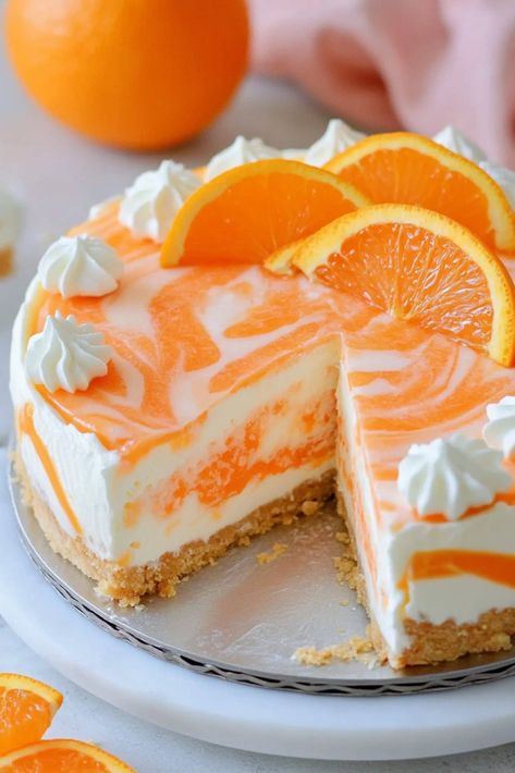 Soft, rich, and oh-so-fruity, this no-bake orange creamsicle cheesecake is an irresistible summer dessert that tastes just like the classic frozen treat. No Bake Creamsicle Cheesecake, Orange Cream Cheesecake, Orange Creamsicle Recipes, Orange Dreamsicle Cheesecake, No Bake Orange Creamsicle Cheesecake, Orange Party Food, Orange Dessert Recipes, Healthy Orange Cake, No Bake Birthday Cake