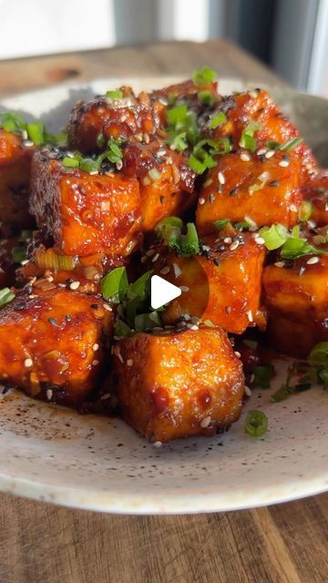 rhian melvin on Instagram: "CRISPY CHILLI GARLIC TOFU 🌶️

this tofu has been a firm fave I always return to for yearrrrrs- it was actually one of my of recipes when I first started doing recipe vids !!

the crispy tofu, the umami, spicy, perfectly balanced sauce- hands down one of the dreamiest recipes I’ve made x

ingredients (serves 2)

300-400g firm tofu, torn into rough chunks
2 tbsp crispy chilli oil
2 tbsp tamari (or dark soy sauce)
1/2 tbsp agave
1/2 tbsp rice vinegar
4 tbsp water
5 tbsp & 2 tsp cornstarch
4 cloves garlic, minced
2 large spring onions, sliced, whites separated from green
sesame seeds to garnish

method:

1. toss the tofu in 5 tbsp of the cornstarch & season with salt & pepper. fry until golden & crisp then remove from the pan & set aside
2. mix the crispy chilli oi Crispy Chilli Oil, Garlic Tofu, Dark Soy Sauce, Chilli Oil, Firm Tofu, Crispy Tofu, Spring Onions, Spring Onion, Pan Set