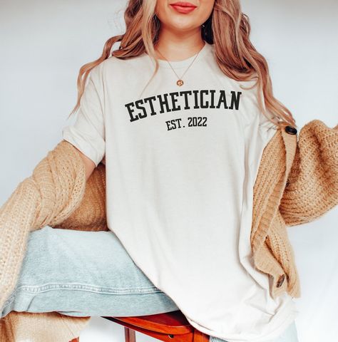 "This college letter \"esthetician est. 2022\" tee can be personalized/customized to the year you want! This soft shirt would make the perfect graduation gift for new licensed estheticians! Want this design on a sweatshirt instead? You can find it here: https://www.etsy.com/listing/1242398488 Be sure to checkout my shop for more esthetician tees & sweatshirts! *HOW TO ORDER* 1. Look through photos at the different colors and the sizing chart (all shirts & sweatshirts are unisex!) 2. Select your Esthetician Apparel, Hair Stylist Shirts, Boss Tshirt, Esthetician Gifts, Artist Tees, Boho Mode, Artist Shirts, Rad Tech, Tech Shirt