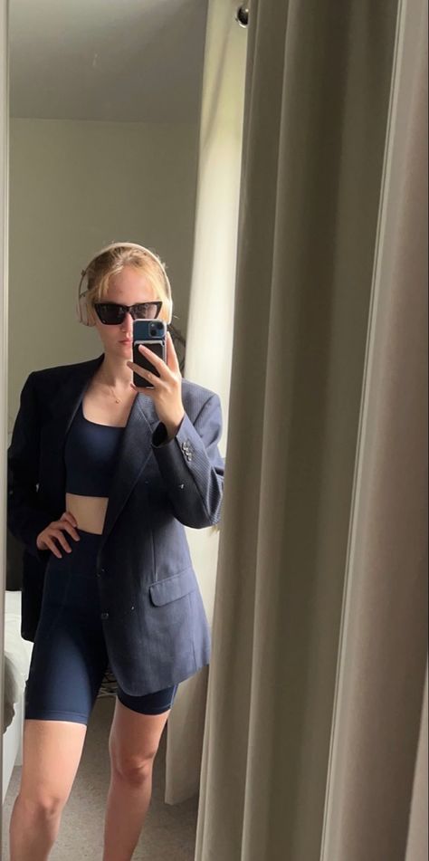 girl in pinstriped oversized navy blazer and navy cycling shorts and sports bra, hair in a messy bun with cat-eye sunglasses and beats headphones on Girlfriend Collective, Leather Skirt, Headphones, Active Wear, Mirror Selfie, Blazer, Sunglasses, Wardrobe, Leather