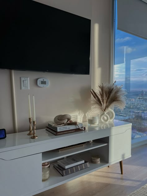 nyc apartment, decoration ideas, new home, new apartment, TV consol, neutral aesthetics, rattan, laurentiby, candle sticks, coffee table books, TV decoration, big windows Tv Table Aesthetic, Condo Goals, Tv Apartment, Apartment Decoration Ideas, Tv Decoration, Dope Rooms, Apartment Tv, Boston Apartment, Rich Decor