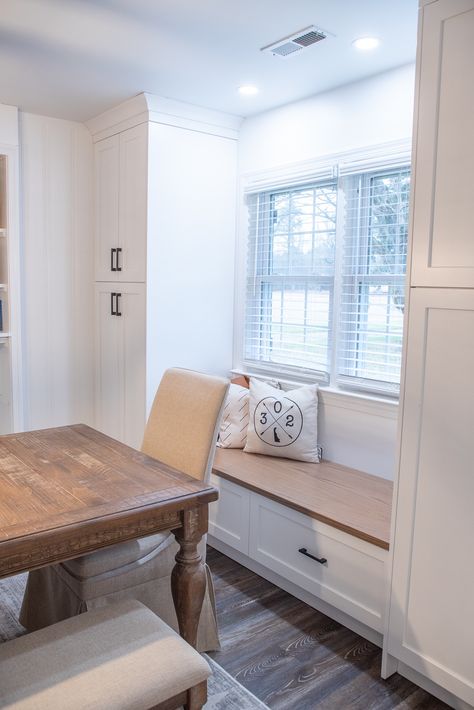 White shaker style cabinetry. Two tall pantry cabinets with a bench seat under a window. Kitchen Built In Around Window, Kitchen Bench Under Window, Bench Between Cabinets, Kitchen Bench Seating Under Window, Built In Pantry Cabinet Wall, Window Bench Seat, Wall Bench, Tall Pantry Cabinet, Window Seat Kitchen