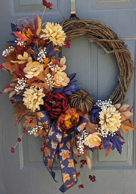 Welcome fall and your guest with this beautiful autumn wreath. This beauty has cream Chrysanthemums, cream blush Roses, Burgandy and rust colored faux Peony flowers mixed with blue, gold and red maple leaves, with white berry picks. This unique wreath is adorned with a cute twig pumpkin and a blue leaf bow.  Perfect front door decor for fall or housewarming gift,   Made on a 18 inch grapevine wreath secured with hot glue.  Blue bow with metallic leaves.   Overall size with flowers and greenery 30x26x5 1/2.  Best on a covered porch away from the elements. Shipping is free, once the wreath ships it cannot be cancelled.  To be environmentally friendly wreaths are securely packaged in a recycled box when possible. Fall Wreath With Blue, Door Reef, Blue Wreaths, Fall Porch Decorating Ideas, Fall Wreath Ideas, Elegant Fall Wreaths, Farmhouse Blue, Fall Grapevine Wreath, Fall Mesh Wreaths