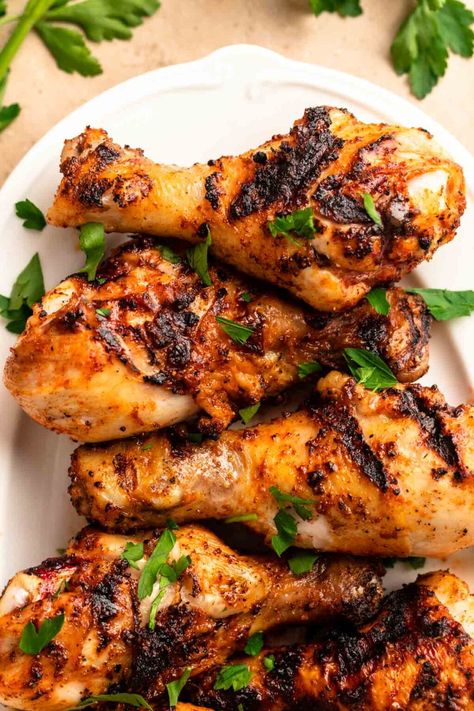 Top of grilled chicken legs on a large white plate. Chicken Drumstick Marinade, Camping Meal Ideas, Grilled Drumsticks, Campfire Foods, Grilled Chicken Drumsticks, Bbq Chicken Drumsticks, Grilled Chicken Legs, Chicken Drums, Bbq Chicken Legs