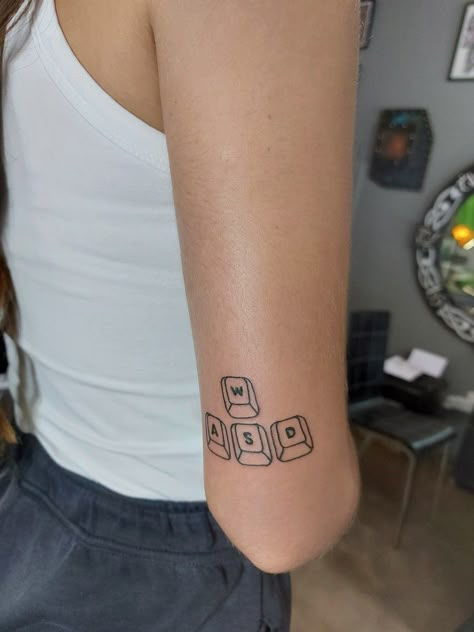 simple wasd gaming tattoo above the elbow Small Game Tattoos, Wasd Gamer Tattoo, Matching Gaming Tattoos, Matching Minecraft Tattoos, Matching Video Game Tattoos, Life Is A Game Tattoo, Gamer Couple Tattoos, Gamer Tattoo Ideas, Roblox Tattoo