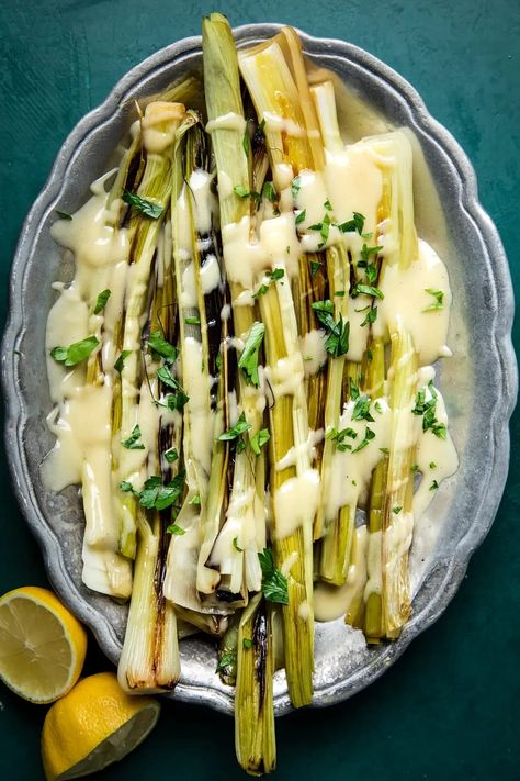 Braised leeks drizzled with a rich French butter sauce—aka beurre blanc—make an elegant side dish for your holiday table. French Side Dishes, Braised Leeks, French Sauces, Leek Recipes, Best Thanksgiving Side Dishes, The Modern Proper, Modern Proper, Creamed Leeks, French Butter