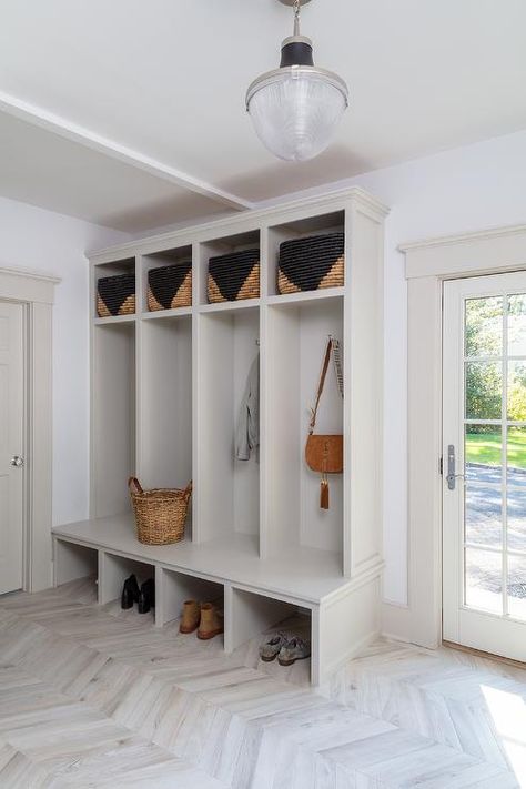 Light gray mudroom bench with open lockers display open lower cubbies and upper cubbies displaying black woven bins. Entry Lockers, Mudroom Ideas Entryway, Foyer Paint, Built In Cubbies, Mudroom Cubbies, Sleek Fireplace, Wall Cubbies, Built In Lockers, Mudroom Cabinets