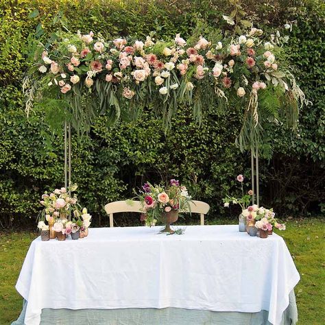 Hanging flowers over top table wedding ideas Flowers Over Table Wedding, Diy Hanging Flowers Over Table, Hanging Flowers Over Head Table, Garden Party Hanging Flowers, Table With Hanging Flowers, Hanging Table Decor, Over The Table Flower Rod, Table Rod Stand Decor, Over The Table Rod Decor Wedding