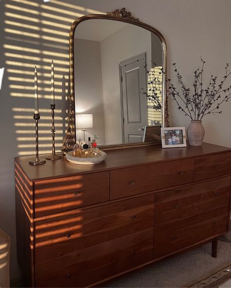 Wood Dresser Bedroom Ideas, Minimal Dresser Styling, Oval Mirror Over Dresser, Bedroom Commode Ideas, Brown Wood Dresser Bedroom, Midcentury Dresser Styling, Vintage Wood Dresser Bedroom, Desk And Dresser In Bedroom, Big Mirror On Dresser