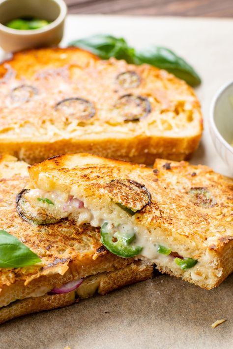 This Vegan Jalapeño Popper Grilled Cheese is the ultimate comfort food. Coated in vegan parmesan and filled with spicy jalapeños & red onion | ThisSavoryVegan.com #thissavoryvegan #vegangrilledcheese #vegansandwich Vegan Grilled Cheese Sandwich, Easy Vegetarian Sandwiches, Vegan Wraps Lunch, Vegan Bbq Food, Vegetarian Comfort Food Recipes, Vegan Picnic Food, Rainbow Rangoli, Popper Grilled Cheese, Vegan Snacks On The Go