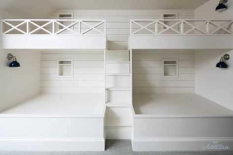 A white built-in staircase is fixed between white built-in bunk beds fitted against a shiplap trim surrounding niches and accented with a white lattice guard rail. Built In Bunk Beds, Bunk Bed Designs For Teens, Bunk Beds Small Room, Lake Hartwell, Bunk Bed Rooms, Modern Bunk Beds, Hangout Room, Bunk Beds Built In, Built In Bunks