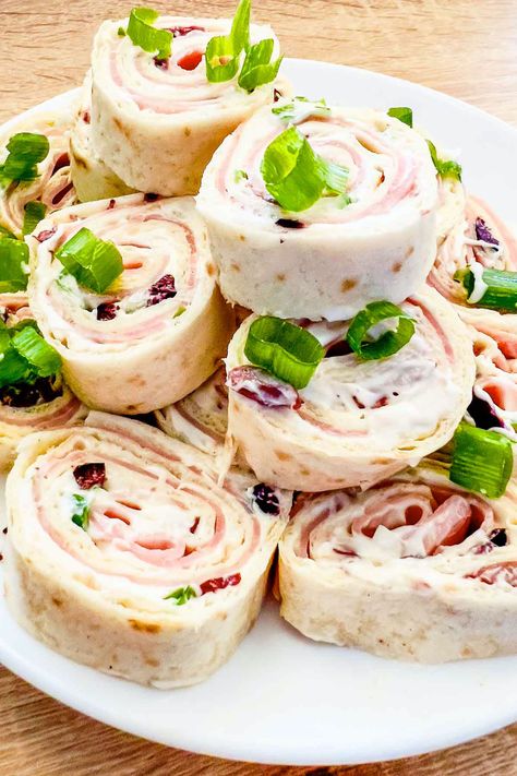 Learn how to make delicious Ham and Cheese Tortilla Roll Ups with this easy recipe. Perfect for parties and snacks, these pinwheels are a hit with everyone. Meat And Cheese Tortilla Roll Ups, Tortilla Ham Roll Ups, Ham Tortilla Roll Ups, Tortillas Roll Ups, Tortilla Roll Ups Cream Cheese, Tortilla Roll Up Recipes, Roll Ups Tortilla Pinwheels, Pinwheel Snacks, Ham And Cheese Tortilla