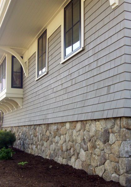 Manufactured stone veneer is a hot new project in 2015, expected to recoup 92.2% of its cost nationally on average. Why not try a stone foundation skirt like this one? Base Of House Ideas, Stone At Bottom Of House, Half Stone Wall Exterior House, Faux Stone Porch Skirting, Houses With Rock Exterior, River Rock Siding Exterior, Stone Foundation Cover, Foundation Stone Ideas, Rock Siding Exterior