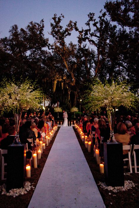 Candle light wedding ceremony in NOMA's Besthoff Sculpture Garden | Romantic wedding ceremony, outdoor wedding ceremony, New Orleans wedding, places to get married in new orleans Outside Wedding Ideas Outdoor Ceremony, Candlelight Wedding Ceremony Outdoors, Candle Aisle Wedding Outdoor, Lit Up Wedding Aisle, Late Night Wedding Ceremony, Candlelit Wedding Ceremony Outdoor, Dim Lit Wedding Ceremony, Outdoor Wedding Candle Decor, Moody Outdoor Wedding Ceremony