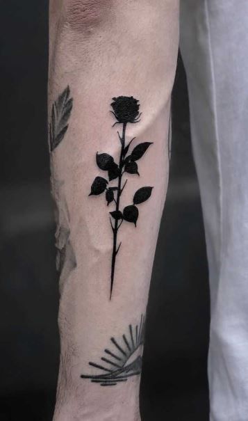 <<Check out more rose tattoos  #tattoomenow #tattooideas #tattoodesigns #rose Rose Unique Tattoo, Rose For Men Tattoo, Black Rose Hand Tattoo Men, Black Out Rose Tattoo, Withering Rose Tattoo, Black Out Design Tattoo, Mens Rose Tattoos, One Rose Tattoo, Rose On Back Tattoo