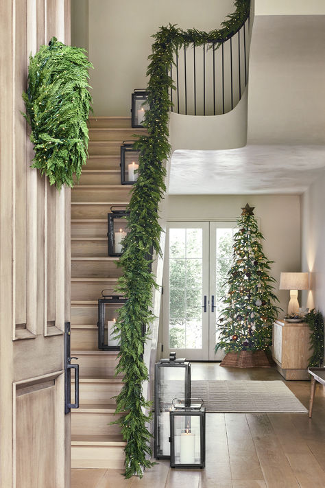 Holiday decor starts here. Shop the very best garland for all your Christmas decor ideas. Our realistic-looking faux botanicals are great for a garland on stairs, garland on mantel, garland over doorway, or anywhere else you want a green Christmas look. Stairs Decorated For Christmas, Decorate Stairs For Christmas Railings, Garland On Stairs Banisters, Garland Christmas Decor Stairs, Garland Hallway, Stair Railing Ideas Christmas Decor, Banister Garland Christmas, Stairway Christmas Decor, Garland Over Doorway