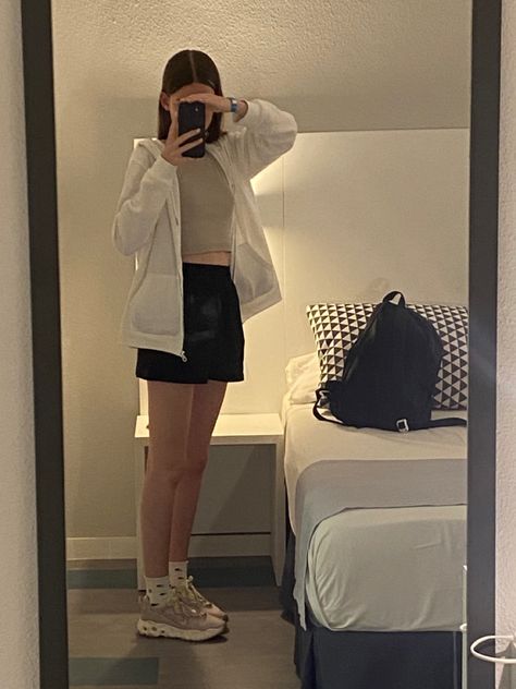 Comfy fit, travel outfit, cute, aesthetic, clothes, plane clothes, travel clothes, black jogger shorts, white zip up hoodie, beige tank top, purple and green trainers, flower cap Plane Clothes, Beige Tank Top, Green Trainers, Travel Clothes, Outfit Cute, Clothes Black, Shorts White, Black Joggers, Purple And Green