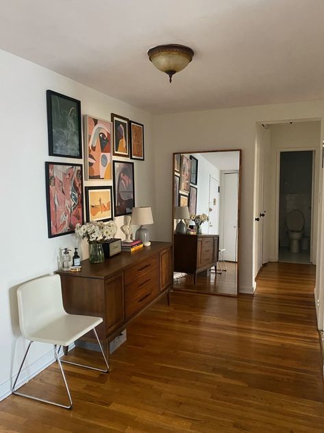 Hallway with frames hanging above buffet and floor-length mirror at the end Floor Length Mirror Bedroom, Brooklyn Apartment Decor, Provincial Bedroom, French Provincial Bedroom, French Provincial Decor, Brooklyn Apartment, Modern Vintage Furniture, Rental Apartment, Side Board